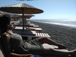 Relaxing on the black sand beach of Perivolos